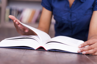 Close up of young woman reading a book