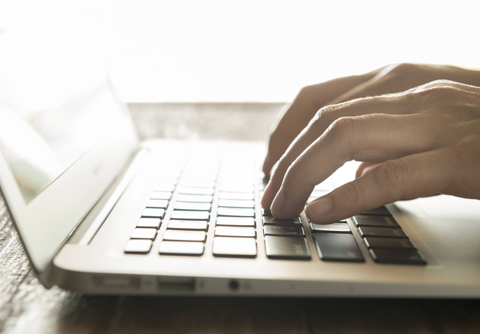 close up of hands on laptop